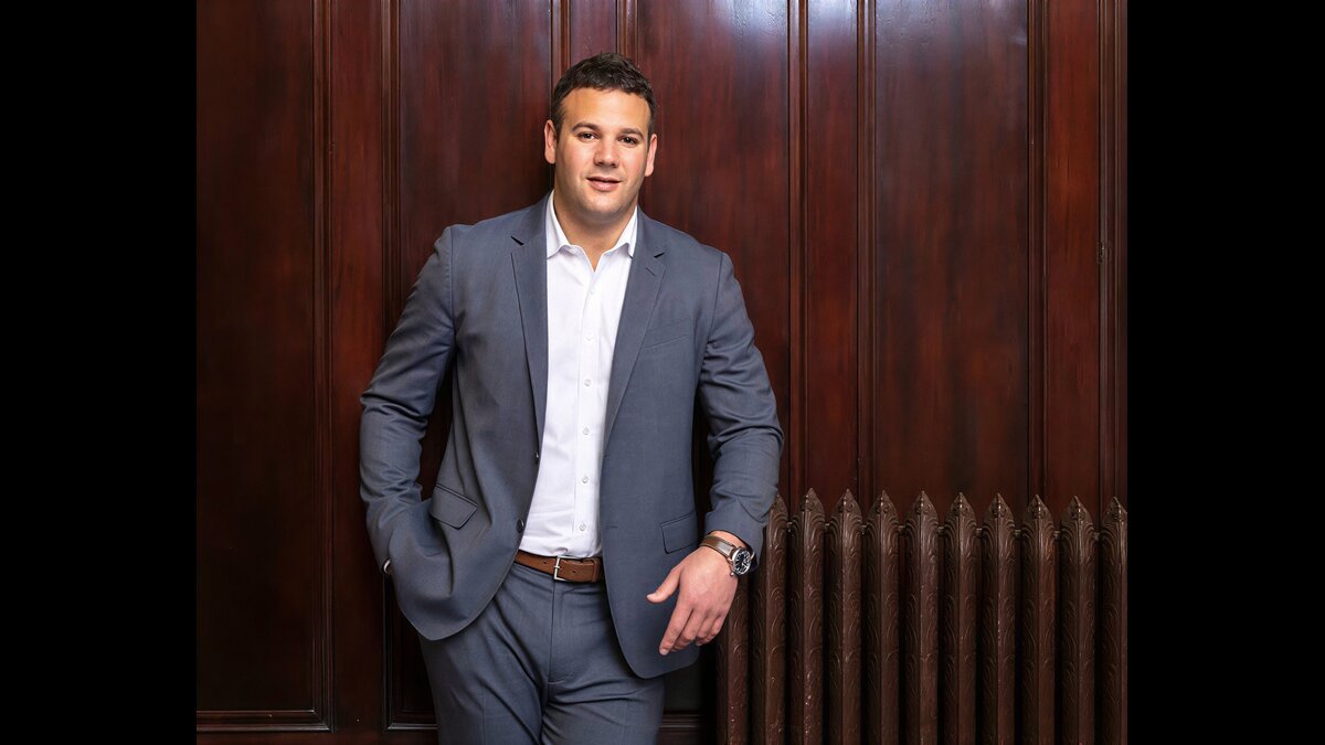 Josh Bartelstein speaking at an NBA event with net worth 2026 title